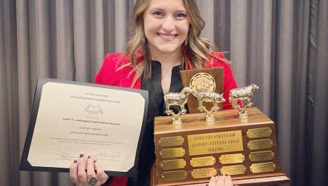 ANSC grad student poses with awards